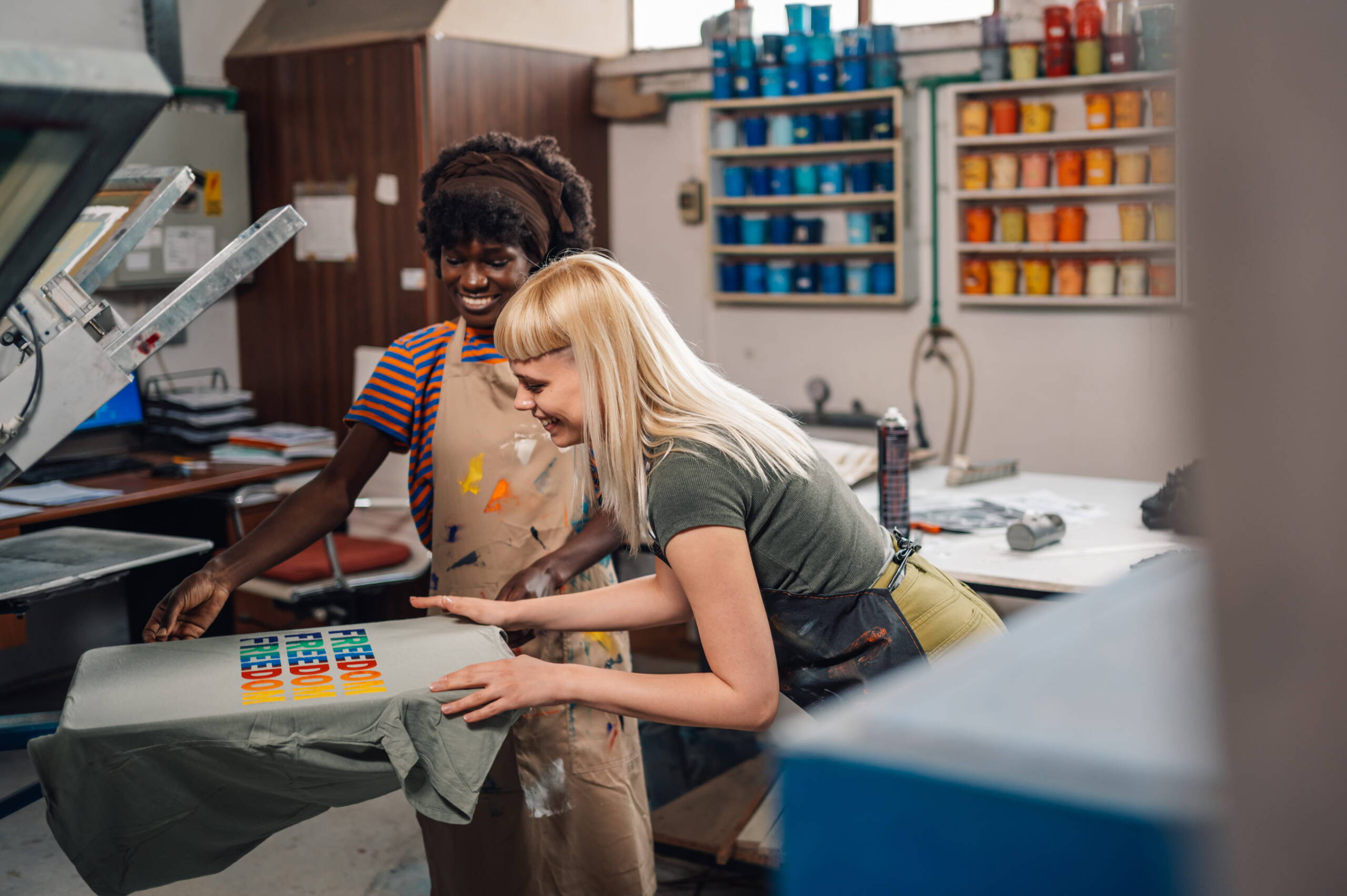 Print shop workers at machine