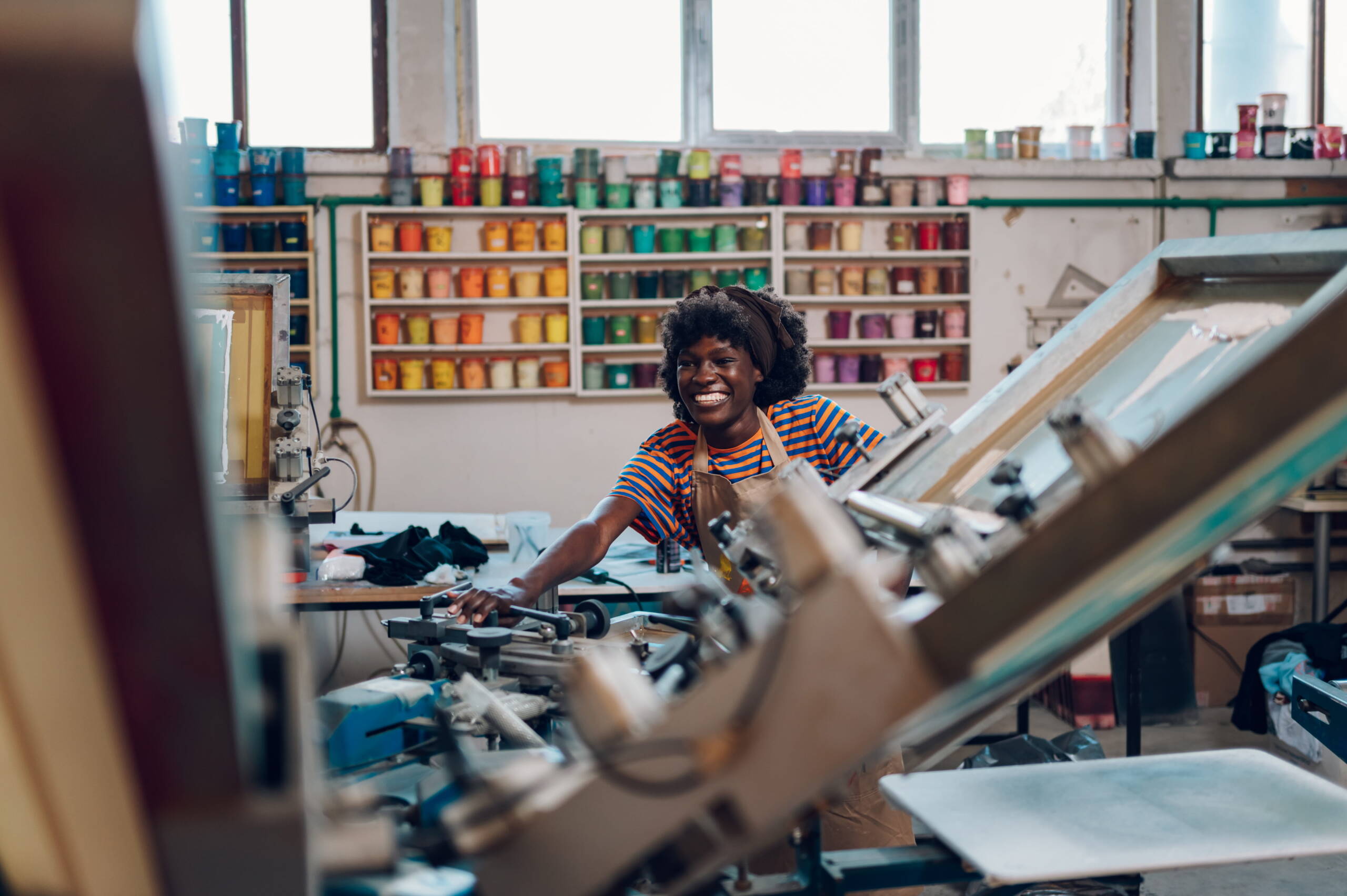 Woman operating screen printing machine